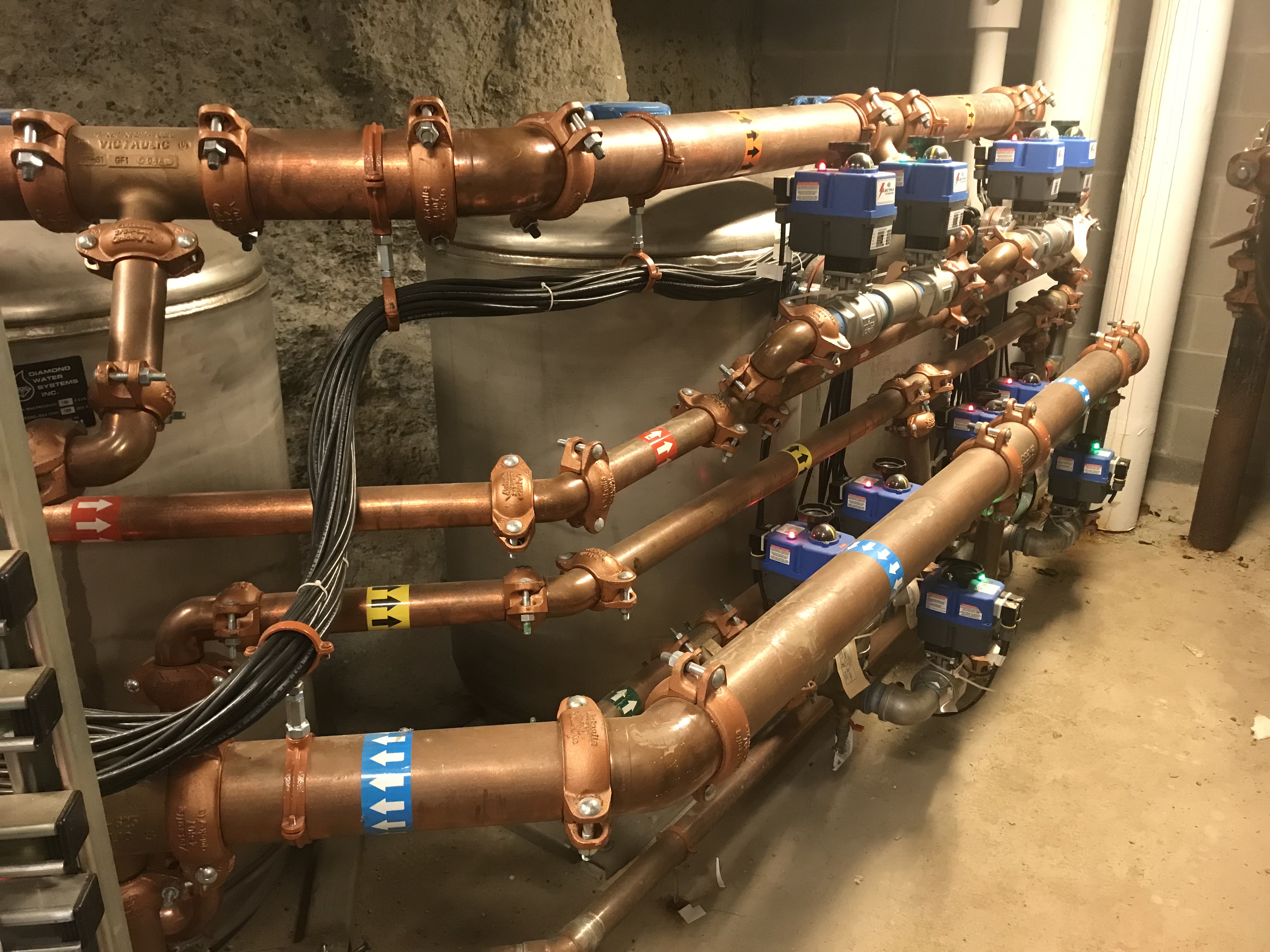 Copper piping manifold connected to Diamond Water Systems filtration tanks